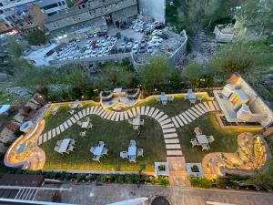 an aerial view of a park with tables and chairs at modern sity hotel in Erbil