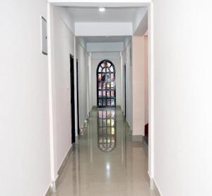 a hallway of a building with a stained glass window at The Mirik Address in Mirik
