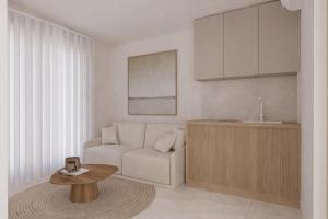 a living room with a chair and a table at Theera by Premium Key in Skiathos
