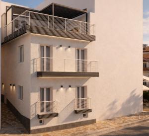 a white building with balconies on the side of it at Theera by Premium Key in Skiathos