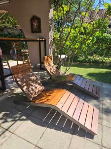 a wooden bench sitting next to a tree at Infinity by the River in Kumanovo +23 photos