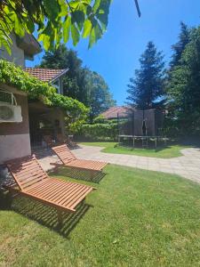 a group of chairs sitting on the grass in a yard at Infinity by the River in Kumanovo