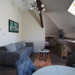 a living room with a couch and a table at Elidon 1833 in Pančevo