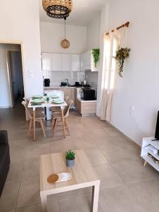 a living room with a table and a kitchen at Canvista in Leptokarya