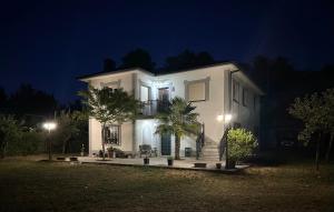a white house at night with lights at Refugio Rural A Revolta in Bergazo