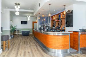 a bar in a restaurant with a wooden counter at North Stafford Hotel in Stoke on Trent