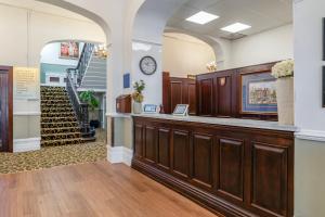 a waiting room with a counter and a staircase at North Stafford Hotel in Stoke on Trent