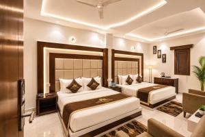 a hotel room with two beds and a couch at Taj View By Signature Stayz in Agra