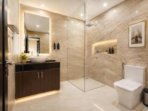 a bathroom with a shower and a toilet and a sink at Taj View By Signature Stayz in Agra +17 photos