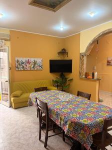 a dining room with a table and a couch at Casa vacanza da Sandro in Priolo Gargallo +9 photos