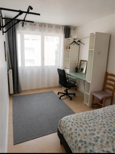 a bedroom with a bed and a desk and a chair at Chambre privée, ANGLET, quartier central in Anglet