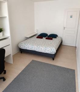 a bedroom with a bed with two pillows on it at Chambre privée, ANGLET, quartier central in Anglet