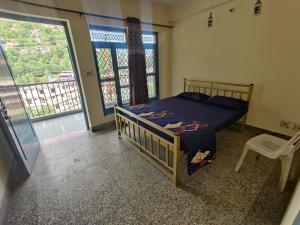 a bedroom with a bed and a large window at Leela's Abode in Bhowāli