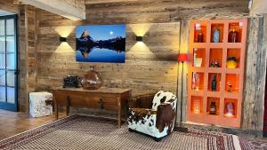 a room with a wooden wall with a desk and a chair at Chalet l'Aiglon in Saint-Gervais-les-Bains