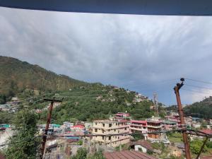 a group of buildings on top of a mountain at Leela's Abode in Bhowāli