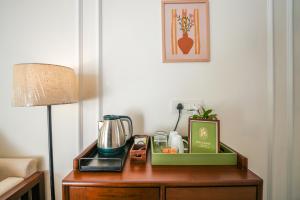 a table with a blender and a lamp on it at Orchard At Sarai - Luxury Tent Villas, Swimming Pool, Large lawns, & Pet friendly in Gurgaon