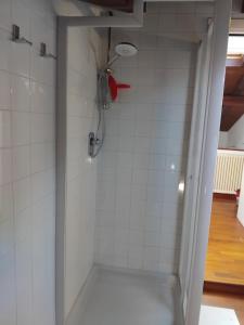 a shower with a red shower head in a bathroom at Sogni in soffitta in Casalecchio di Reno +32 photos
