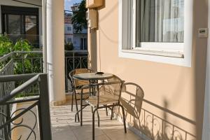 a patio with chairs and a table on a balcony at CALLI HOUSE in Preveza