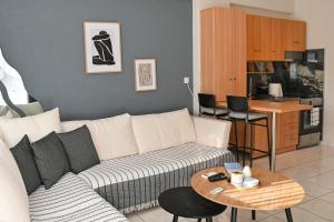a living room with a couch and a table at CALLI HOUSE in Preveza +8 photos