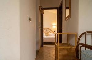 a hallway with a room with a bed and a mirror at House Betania in San Ferdinando +7 photos