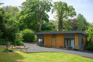 a small house in the middle of a garden at Mill Cottage Garden Studio nr Melrose in Melrose