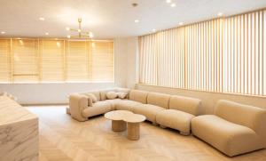 a living room with a couch and a table at Priyado Kochi in Kochi