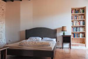 a bed in a room with a book shelf at Saint Germain - Logis de Beaulieu in Poullignac