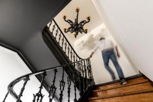 a man walking down the stairs in a house at RM The Experience - Small Portuguese Hotels in Setúbal