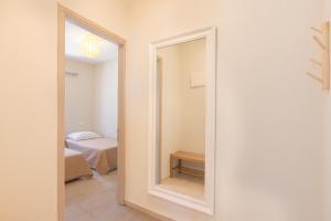 a mirror in a room with a bedroom at Aesop Homes in Pythagoreio +30 photos