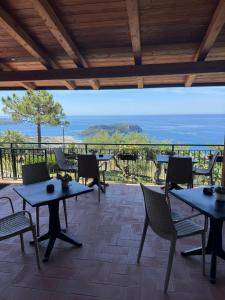 a patio with tables and chairs and a view at B&B Saracinello in Praia a Mare
