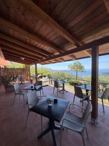 a patio with tables and chairs and a view at B&B Saracinello in Praia a Mare