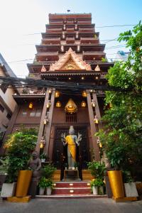 a large building with a statue in front of it at Okay Boutique Hotel in Phnom Penh