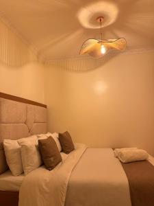 a bedroom with a bed and a ceiling at SerenityLoft by Gloria in Thika