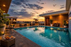 a pool on the roof of a building with a sunset at Taj View By Signature Stayz in Agra