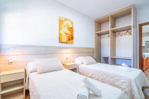 a hotel room with two beds and a mirror at Casa Rural Casita de la Cantera in La Lantejuela +37 photos