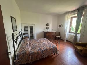a bedroom with a bed and a desk and a window at La Vertecena in Cantalupo nel Sannio