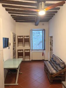 a living room with a glass table and a window at Casa in Corso, Colle Val d'Elsa in Colle di Val d'Elsa
