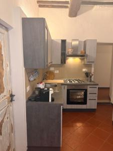 a kitchen with stainless steel cabinets and an oven at Casa in Corso, Colle Val d'Elsa in Colle di Val d'Elsa +5 photos