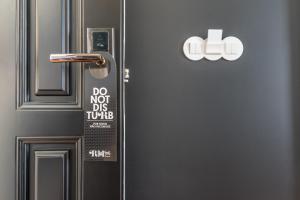 a refrigerator with a sign on the door of it at RM The Experience - Small Portuguese Hotels in Setúbal