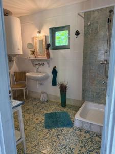a bathroom with a tub and a sink at Mánfa-gyöngy Vendégház in Mánfa +30 photos