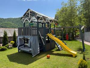 a playground with a slide and a play structure at Mountain Symphony House Dilijan in Dilijan