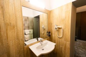 a bathroom with a sink and a mirror at Hotel Casa David in Craiova +39 photos