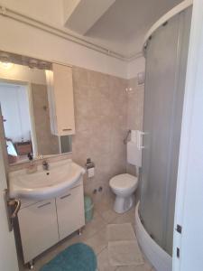a bathroom with a sink and a toilet at Apartments and Studios Vinko Matić in Rab +37 photos