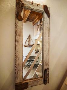 a mirror made out of an old barn wood at Casetta Ismeralda in Carloforte