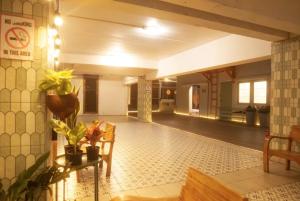 a living room with a tile floor and a table and chairs at Bangkok Group Bunk Hotel Khaosan in Bangkok +74 photos