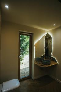 a bathroom with three sinks and a window at Lordis Cabin Tihuța in Piatra Fantanele +45 photos