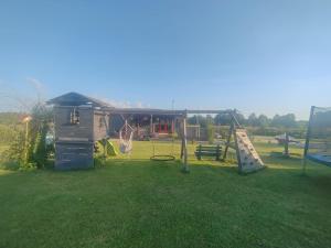 a park with a playground with a swing at Family vacations house in Tīnūži