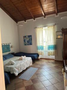 a bedroom with two beds and a window at Rooms Guest House Il Porto Vecchio in Stintino