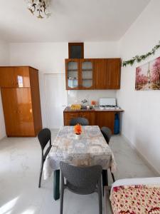a kitchen with a table and chairs in a room at Prime rooms in Durrës