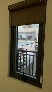 a window with a view of a balcony at Khách Sạn Phượng Vĩ in Cà Mau